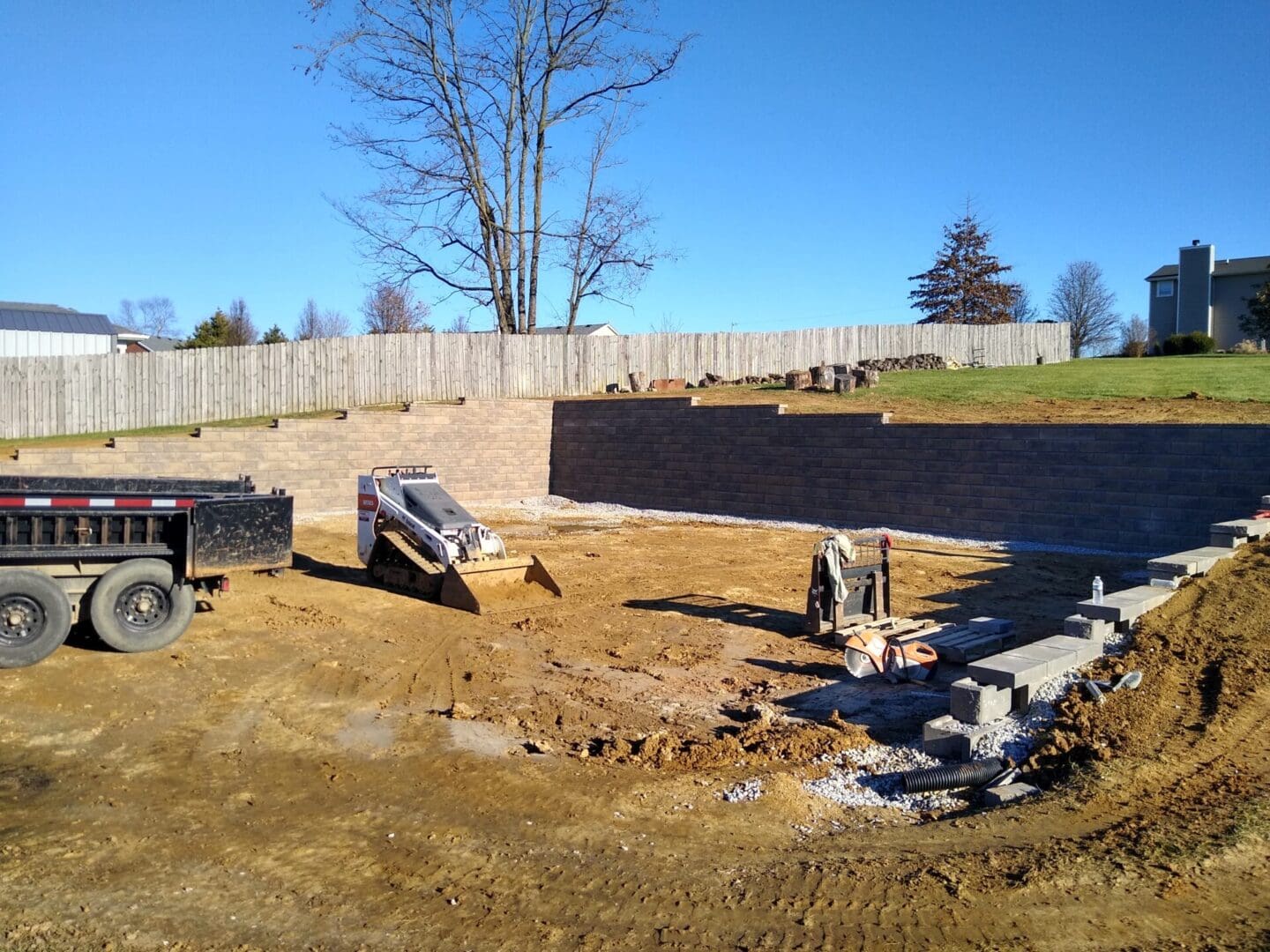 A construction site with a large concrete block wall.
